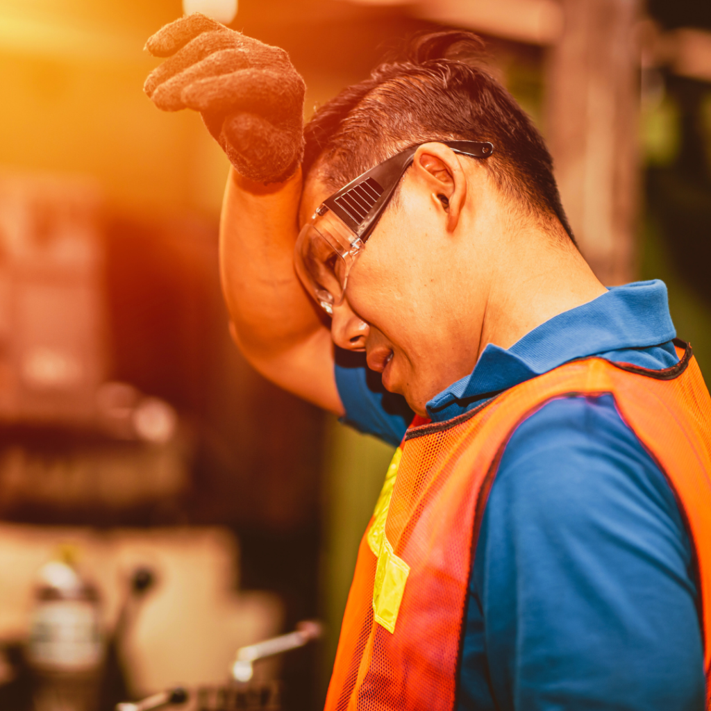 Worker wiping forehead due to heat